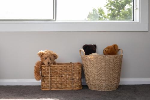 two baskets filled with stuffed animals next to a window at Legana Lodge - A home away from home - Catering for up to 12 guests in Legana