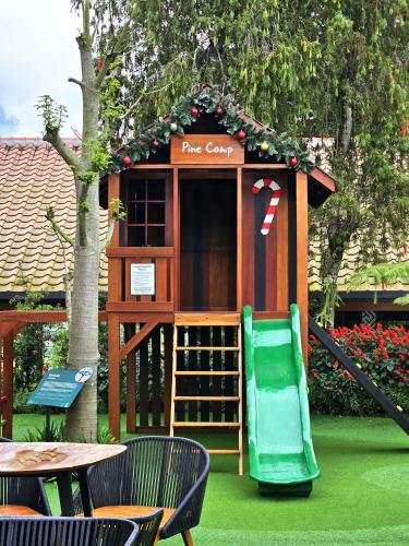 a play house with a slide in a yard at Dusun Bedugul Asri in Bedugul