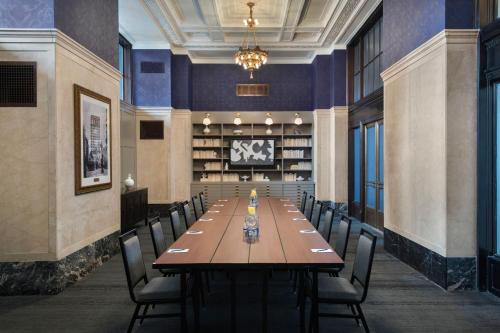 a large dining room with a long table and chairs at The Notary Hotel, Philadelphia, Autograph Collection by Marriott in Philadelphia