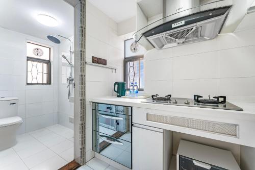 a white bathroom with a sink and a toilet at Meiru Apartment Hotel Guangzhou Bolin Apartment in Guangzhou