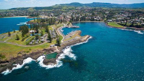 an aerial view of a beach and the ocean at Kiama Harbour Cabins in Kiama