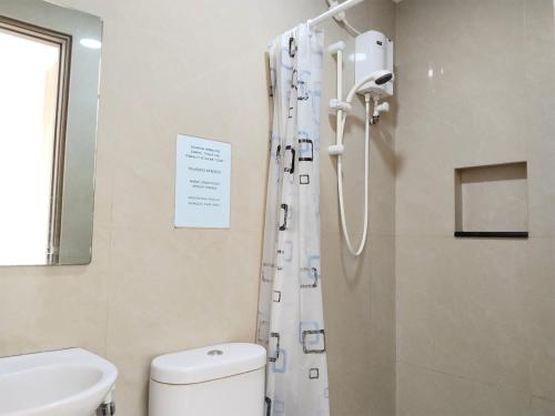 a bathroom with a shower and a toilet and a sink at Portal Residence in Jakarta