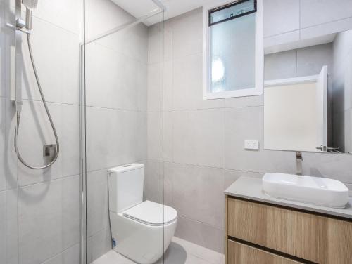 a bathroom with a toilet and a sink and a shower at The Laneway Villas by Burleigh Letting Company in Gold Coast