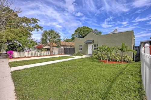 a house with a white fence in a yard at Palm Wave Says - Quiet House in Best Area in West Palm Beach