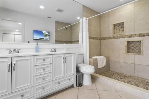 a bathroom with a sink and a toilet and a shower at Palm Wave Says - Quiet House in Best Area in West Palm Beach