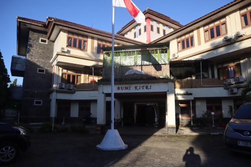 a pole in front of a building with a flag at Hotel Bumi Kitri in Bandung