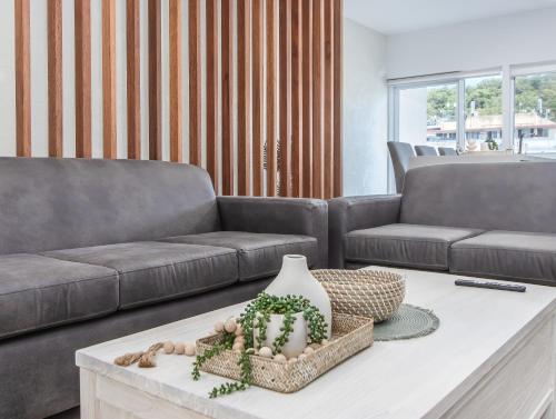 a living room with a couch and a coffee table at The Laneway Villas by Burleigh Letting Company in Gold Coast