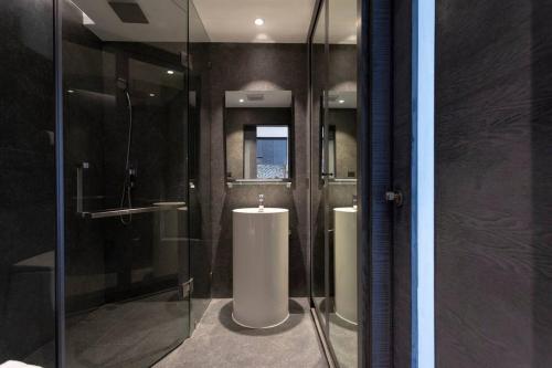 une salle de bain avec une douche en verre et un lavabo dans l'établissement Luxury Resort City Gate Kamala C33, à Kamala Beach