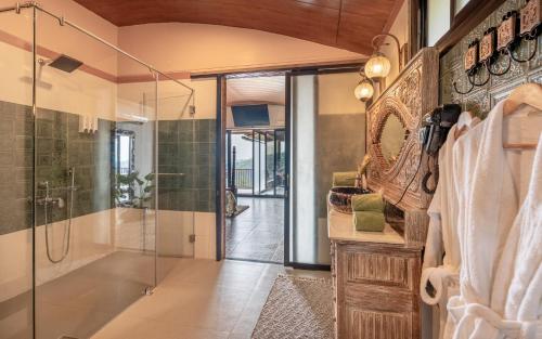 a bathroom with a shower and a glass shower stall at Simroseate in Agonda