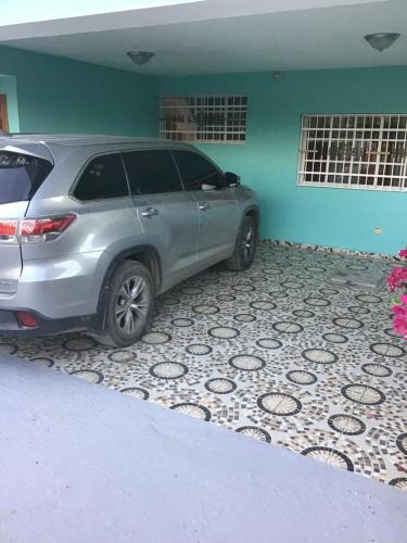 a silver suv parked in a garage at Villa Nilsa ( The Blue House ) in Baní