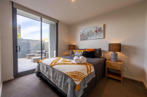 a bedroom with a bed and a large window at Eastside apartment in Charlestown