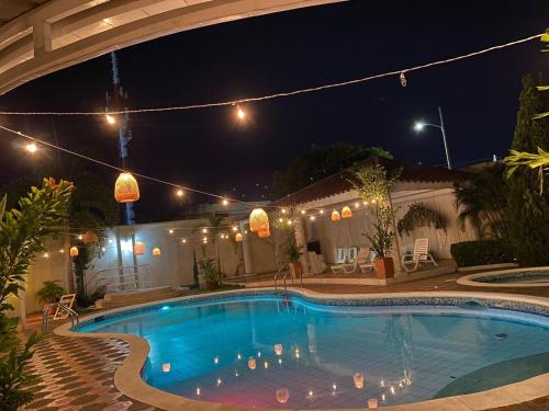 a swimming pool in a backyard at night at Apto Valle Suites, La Mejor Zona in Valledupar