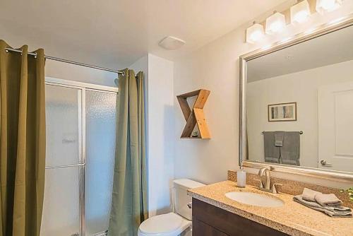 a bathroom with a shower and a toilet and a sink at Shopping & Dining 1 Mile - 24 Hour Pool with Parking - 4036 in Phoenix