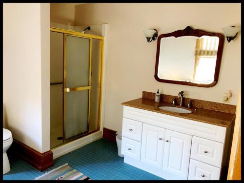 a bathroom with a shower and a sink and a mirror at Beautiful Victorian Home On Ocean Side, in Waretown