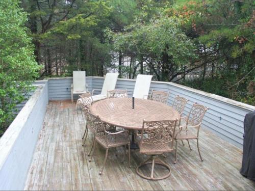 a table and chairs on a wooden deck at Beautiful Victorian Home On Ocean Side, in Waretown
