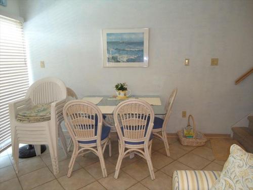 a dining room with a table and chairs at Perfect Bayfront Condo With Beautiful Views Of The Bay in Beach Haven