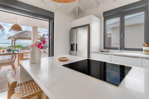 a kitchen with a large white counter and a dining room at 3-bedrooms Villa 5min from Orient Bay in Cul de Sac