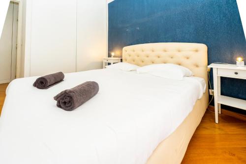 a bedroom with a white bed with towels on it at Palais Magnan Lux 4 Pers WiFi AC in Nice
