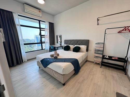 a bedroom with a bed and a large window at JQ1 SEA & POOL or CITY View WIFI I WASHING MACHINE for Some Units I CUCKOO WATER Jesselton Quay by R2 in Kota Kinabalu
