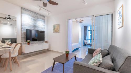 a living room with a couch and a table at Grace Suite @ The Shore KK in Kota Kinabalu
