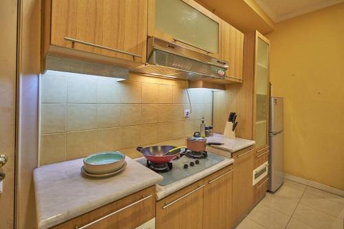 a kitchen with a stove and a bowl on the counter at 2BR Magnificent View Apartment at ITC Kuningan in Jakarta