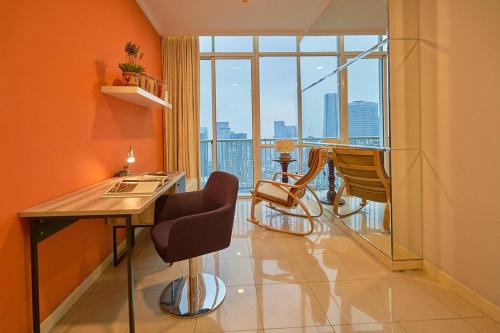 a room with a table and chairs and a large window at 2BR Magnificent View Apartment at ITC Kuningan in Jakarta