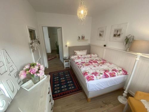 a bedroom with a bed and a vase of flowers at Nordwind Modern retreat in Norddeich