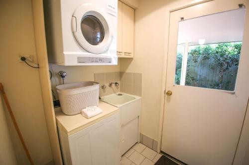 a small bathroom with a sink and a washing machine at Silver Birches Holiday Village - Unit 8 in Bright