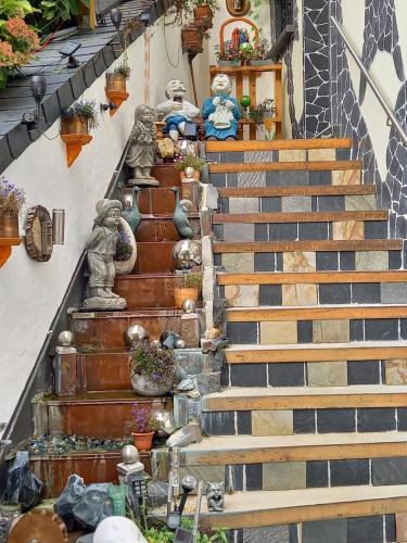 a set of stairs with statues and potted plants at Parkhotel an der Therme in Herbolzheim