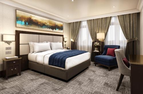ロンドンにあるRochester Hotel by Blue Orchidのベッドと椅子付きのホテルルーム