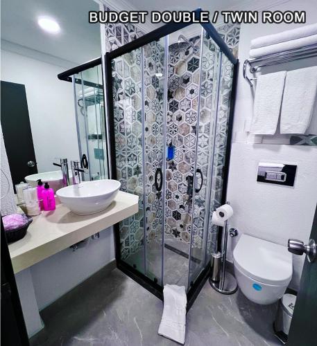 a bathroom with a shower with a toilet and a sink at Angel's Home Hotel - Angel Group Hotels in Istanbul