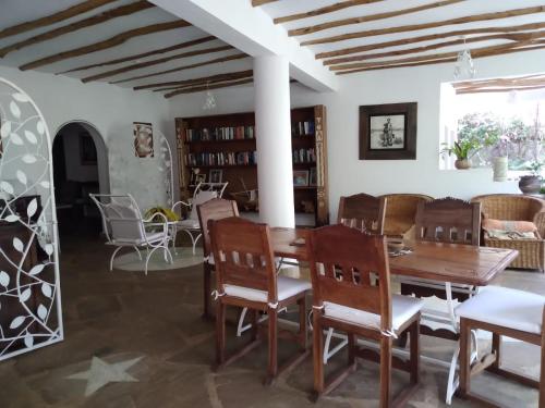 a dining room with a table and chairs at Mwezi Nyota in Malindi