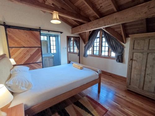 a bedroom with a bed in a room with wooden floors at Amani House in Nairobi