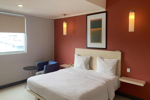 Postel nebo postele na pokoji v ubytování Hotel Glodok Plaza