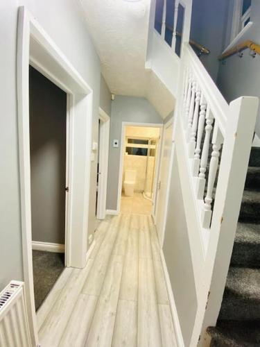 a hallway of a home with stairs and a stair case at Malborough - a lovely 3 bed house for short or long-term stays in Derby