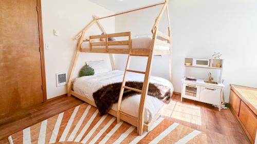 a bedroom with a bunk bed with a ladder at Hot tub, Pool Table, Rv Parking! in Mount Hood Village