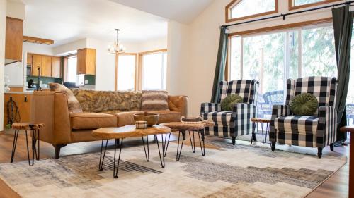 a living room with a couch and two chairs at Hot tub, Pool Table, Rv Parking! in Mount Hood Village