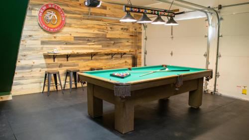 a room with a pool table in front of a wall at Hot tub, Pool Table, Rv Parking! in Mount Hood Village