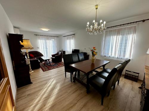 a living room with a dining room table and chairs at AJO Vienna Ambassador Family House with Free Parking in Vienna