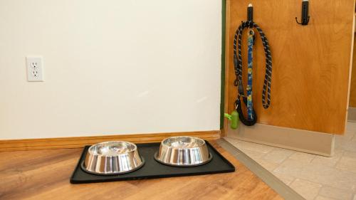two bowls on a tray on the floor next to a door at Hot tub, Pool Table, Rv Parking! in Mount Hood Village