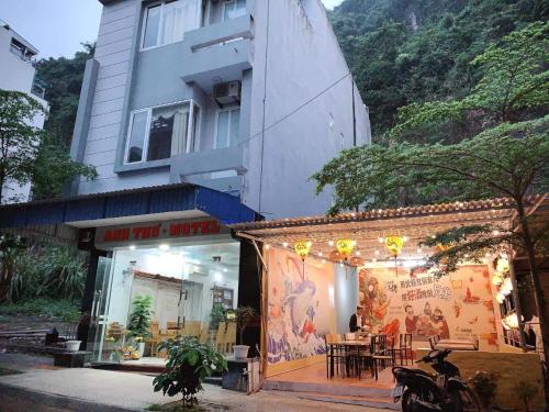 a building with a restaurant in front of it at NA NA Homestay in Cat Ba