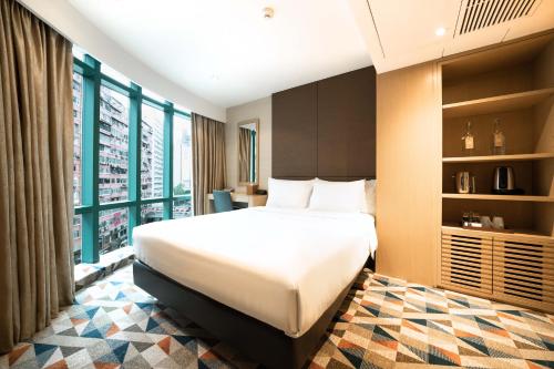 a hotel room with a bed and a large window at Eaton HK in Hong Kong
