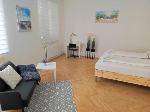 a living room with a bed and a couch at Haus Semmi in Fürstenfeld