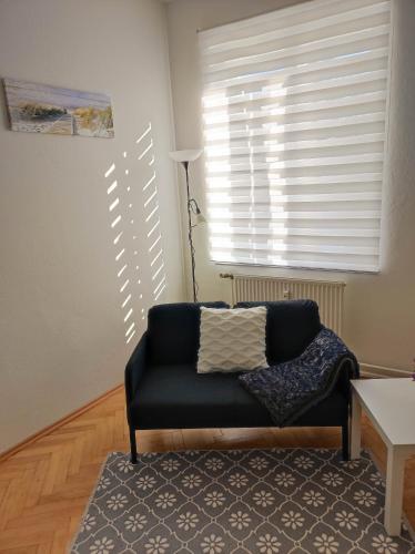 a living room with a couch and a window at Haus Semmi in Fürstenfeld