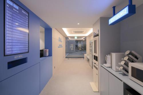 a hallway in a hospital with a sign on the wall at Annk Air Hotel Daejeon Munchang in Geochang