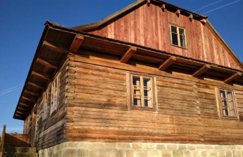 a wooden building with windows on top of it at Ferienhaus in Zawada mit Grill und Terrasse 