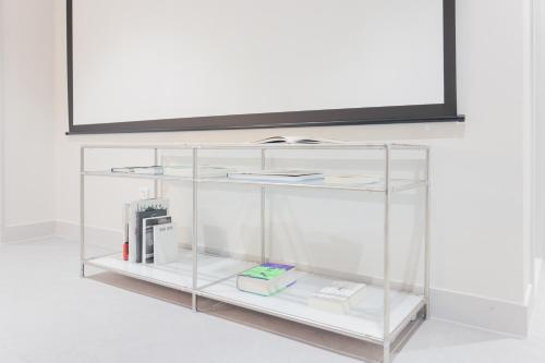 a glass shelf with a tv on top of it at Aank Air Hotel Daejeon in Geochang