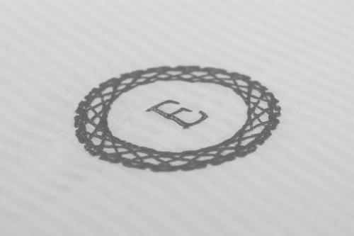 a black coiled rope on a white blanket at Eletta Guest House in Rome