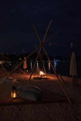 a beach at night with a light on the sand at Mark Warner Phokaia Beach Resort in Foca
