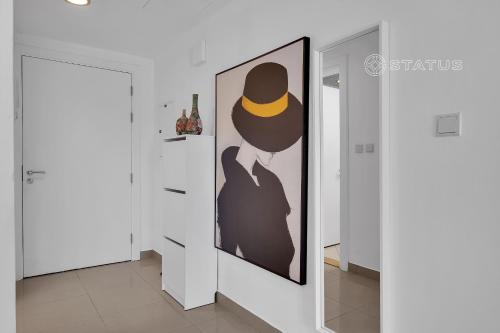 a painting of a man with a hat on a wall at Sleek Studio - Red Residence-L8 - Near ISD Stadium in Dubai